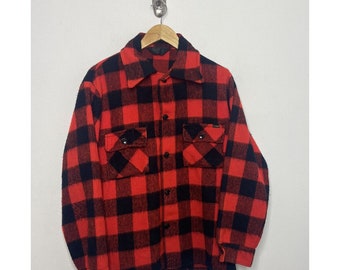 May include: Red and black plaid flannel shirt with a button-up front and two flap pockets.