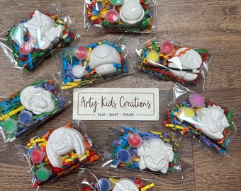May include: Nine individual paint-your-own character kits, each containing a white ceramic figurine, paint pots, a paintbrush, and colorful shredded paper. The characters include Mario, Luigi, Toad, Yoshi, Bowser, and others.