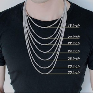 May include: A person wearing a black t-shirt with multiple silver chain necklaces of varying lengths. The necklaces range from 18 to 30 inches in length, with each length clearly labeled in white text.