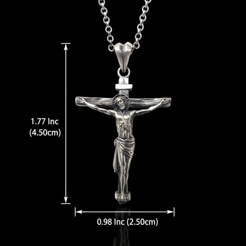 May include: Silver-toned crucifix pendant necklace. The pendant depicts Jesus on the cross, with measurements of 1.77 inches (4.50cm) in height and 0.98 inches (2.50cm) in width. The necklace has a chain and a clasp.