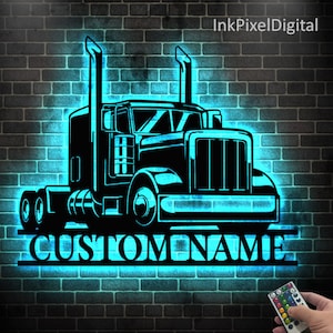 May include: Black metal truck silhouette with the words "CUSTOM NAME" illuminated in blue neon against a brick wall. The image includes a remote control for the neon lights. The product is a personalized wall decor item.