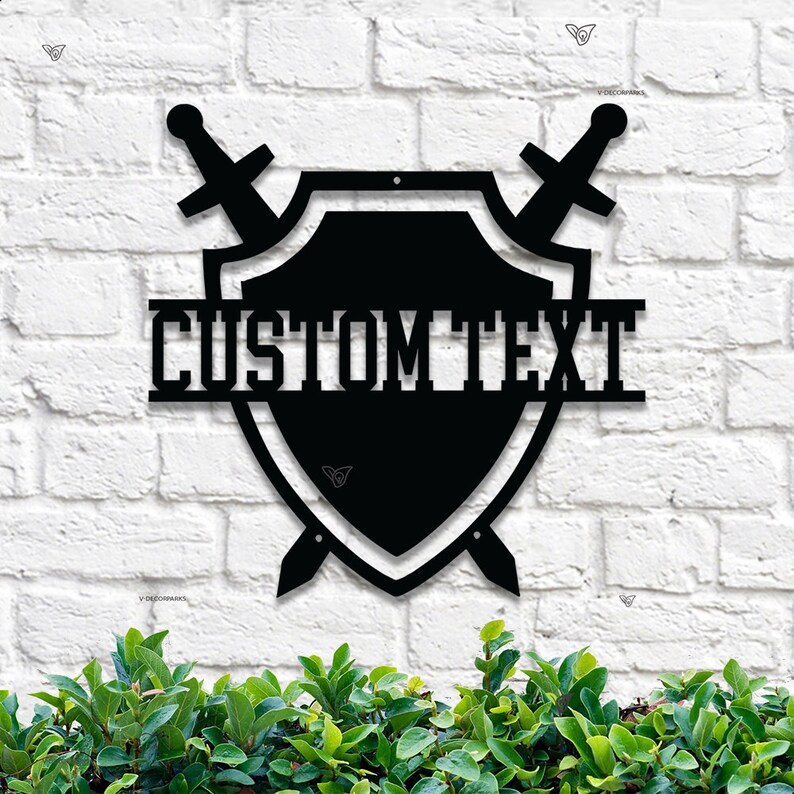 May include: Black metal shield with two swords crossed behind it. The shield has the text "CUSTOM TEXT" on the top.