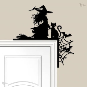 May include: Black silhouette of a witch with a cat, broom, bats, and a spiderweb, designed to be placed on a door frame. The witch wears a pointed hat and flowing dress, perfect for Halloween decorations.