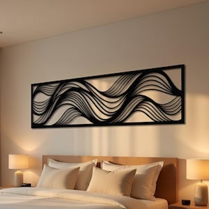 May include: Black metal wall art featuring a flowing, wave-like design. The artwork is rectangular and mounted above a bed with cream-colored bedding. The room is lit by lamps on the nightstands.