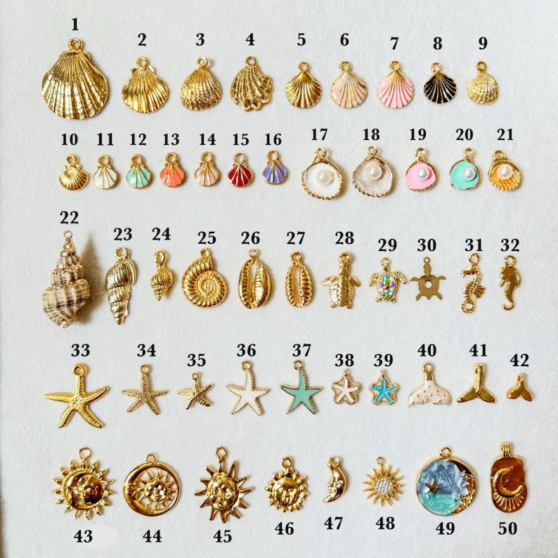 May include: A collection of 50 gold-toned and colorful seashell, starfish, and ocean-themed charms. The charms vary in size and design, including shells, seahorses, and suns, perfect for jewelry making.