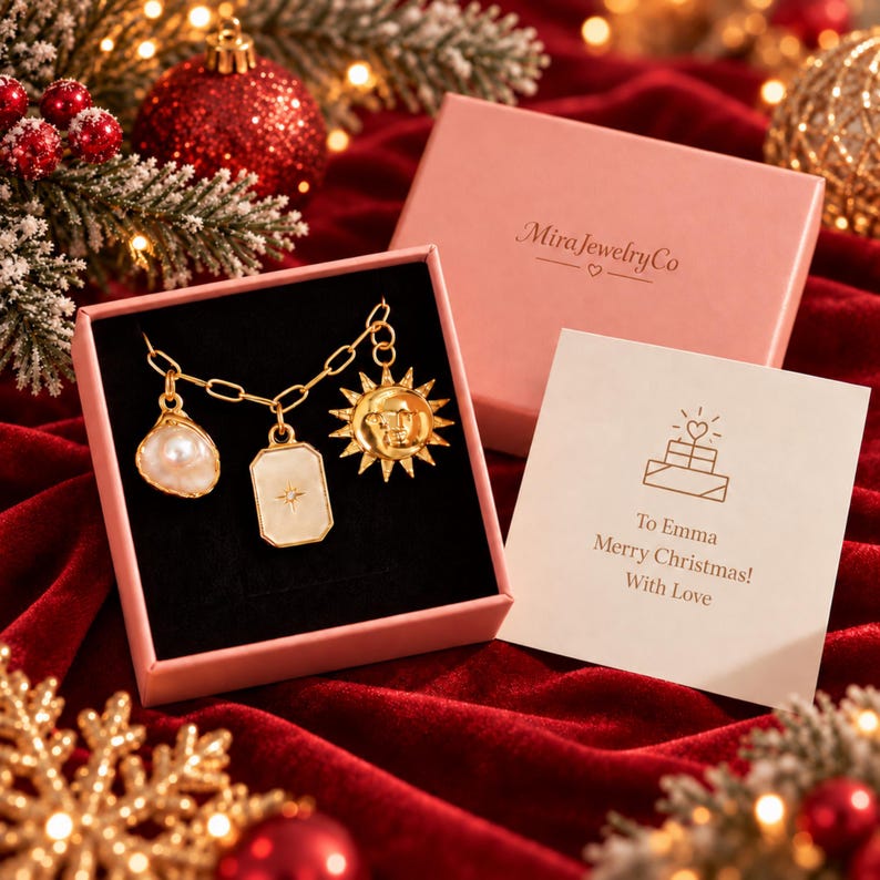 May include: A gold chain bracelet with three charms: a white pearl, a rectangular pendant with a star engraving, and a sun face medallion. The bracelet is inside a pink gift box labeled MiraJewelryCo with a card reading To Emma Merry Christmas! With Love.
