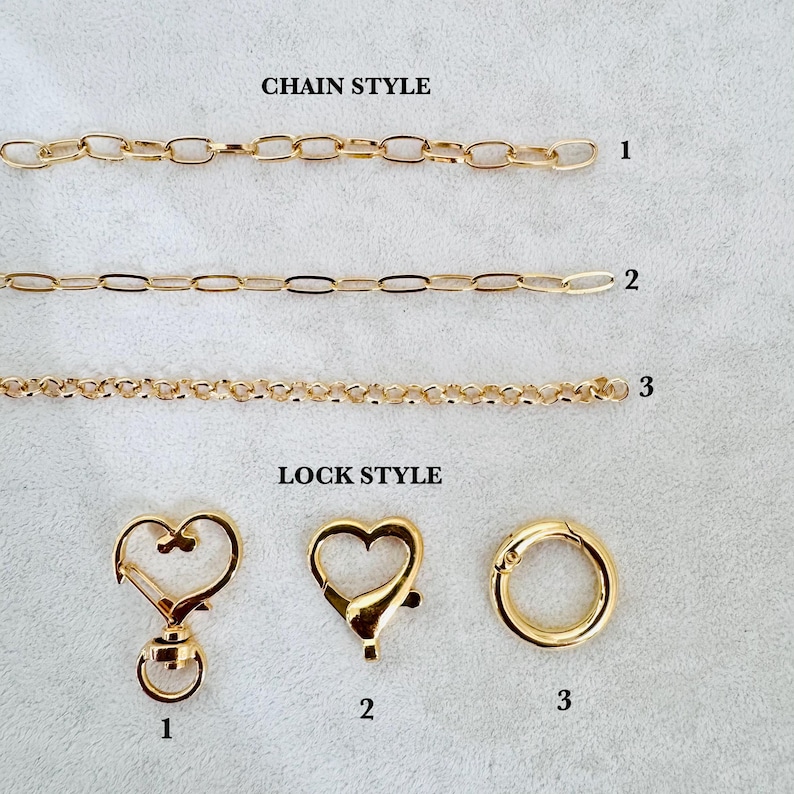 May include: Three gold-toned metal chains labeled 1, 2, and 3 under the text CHAIN STYLE, and three gold-toned metal clasps labeled 1, 2, and 3 under the text LOCK STYLE. The clasps include a heart-shaped swivel, a heart-shaped lobster, and a ring.