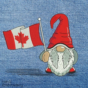 May include: A red and white Canadian flag is held by a gnome with a red hat and white beard. The gnome is standing on a blue denim background.