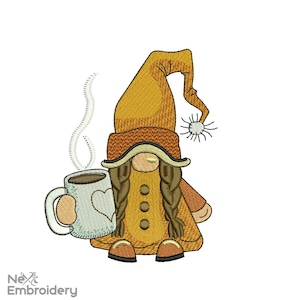 May include: Embroidered design of a gnome holding a coffee mug with steam rising from the mug. The gnome is wearing a brown hat with a yellow brim, a yellow coat, and brown boots. The gnome has brown hair in braids.