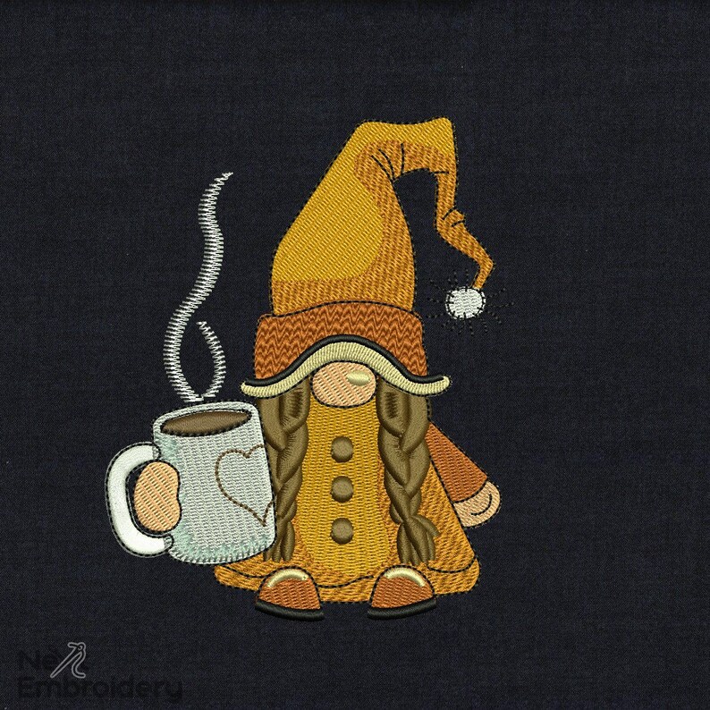May include: A brown and yellow gnome with long brown braids is holding a white coffee mug with a brown liquid and steam coming from the top. The gnome is wearing a brown and yellow hat with a white pom-pom.