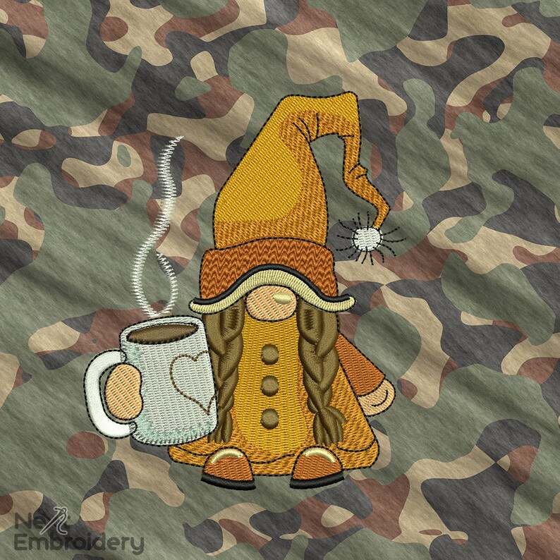 May include: Embroidered design of a gnome holding a white coffee mug with a heart on it. The gnome is wearing a yellow hat, brown boots, and a yellow and brown outfit. The background is a camouflage pattern.