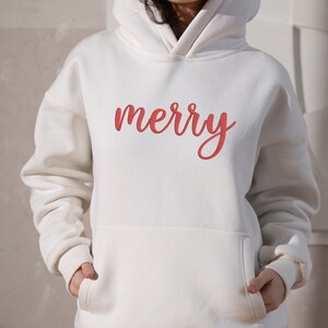 May include: White hoodie with a red "merry" embroidered on the front.