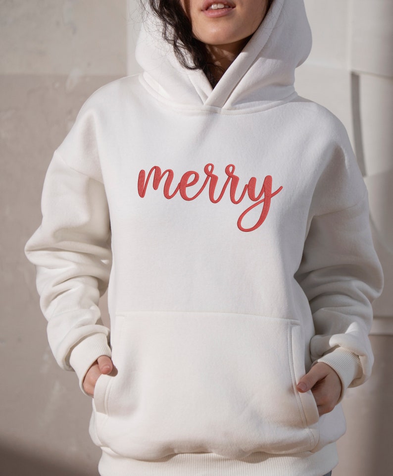 May include: White hoodie with a red "merry" embroidered on the front.