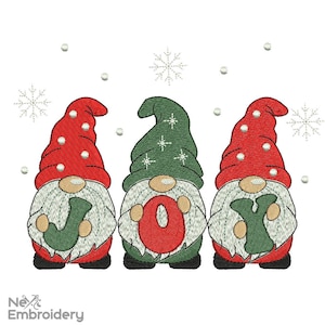 May include: Three embroidered Christmas gnomes with red and green hats, white beards, and holding letters that spell "JOY". The gnomes are decorated with snowflakes and small white dots on a white background.