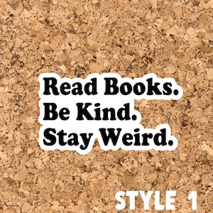 May include: A corkboard with a white sticker that reads "Read Books. Be Kind. Stay Weird." in black text. The text "STYLE 1" is written in white below the sticker.