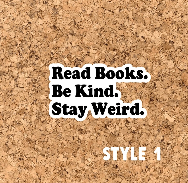 May include: A corkboard with a white sticker that reads "Read Books. Be Kind. Stay Weird." in black text. The text "STYLE 1" is written in white below the sticker.