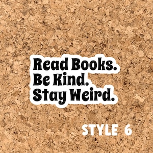 May include: A corkboard with a black and white sticker that reads "Read Books. Be Kind. Stay Weird." and "STYLE 6" in white text.