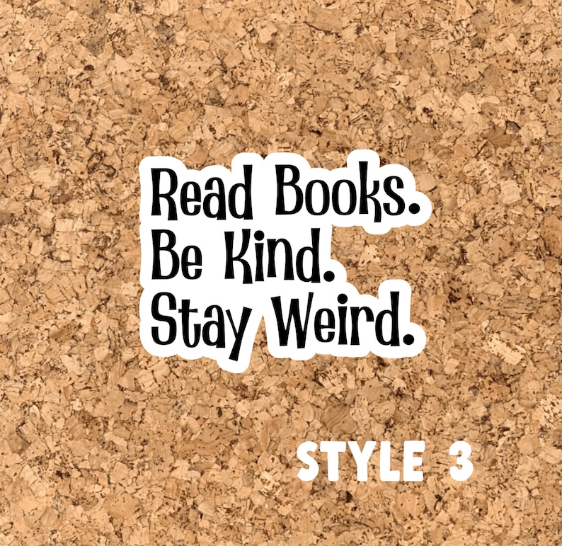 May include: A corkboard with a white sticker that says "Read Books. Be Kind. Stay Weird." in black text. The sticker is on a brown corkboard with the words "STYLE 3" in white text below the sticker.