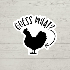 May include: A white sticker with a black silhouette of a chicken and the text "GUESS WHAT?" with an arrow pointing to the chicken's rear end.