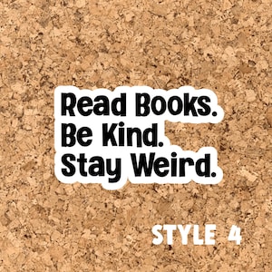 May include: A corkboard with a white sticker that says "Read Books. Be Kind. Stay Weird." in black text. The text "STYLE 4" is printed in black below the sticker.