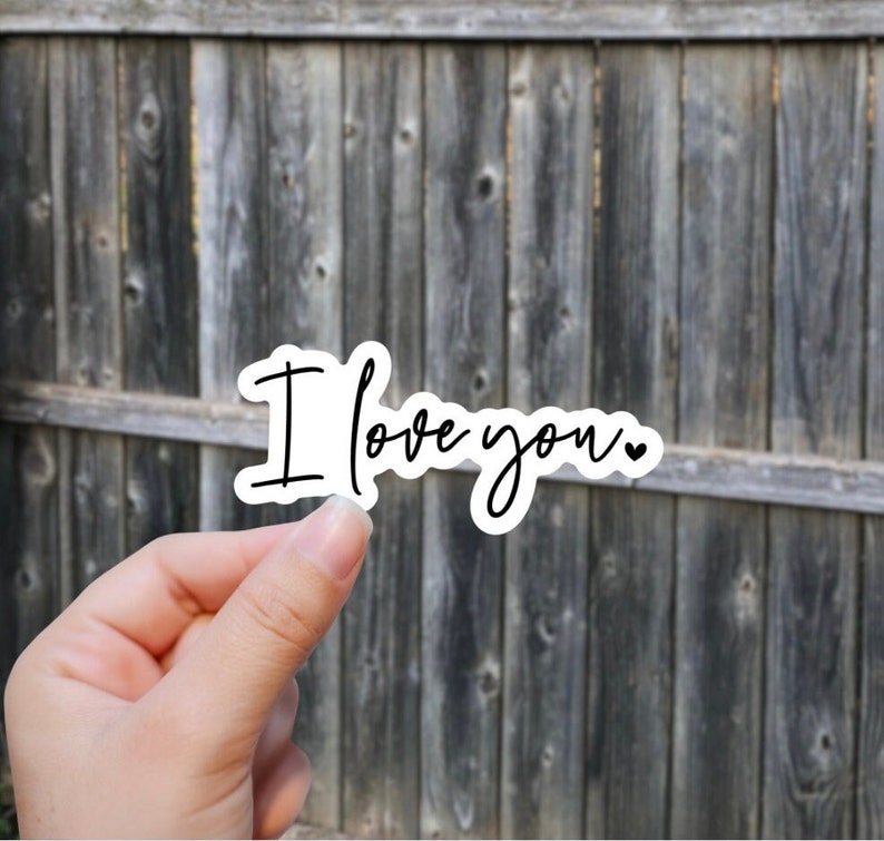 May include: White sticker with the text "I love you" written in black cursive with a small heart symbol at the end.