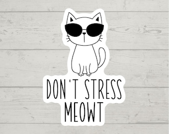 May include: A white cat wearing sunglasses sits with its tail curled around its legs. The text "Don't stress meowt" is below the cat.