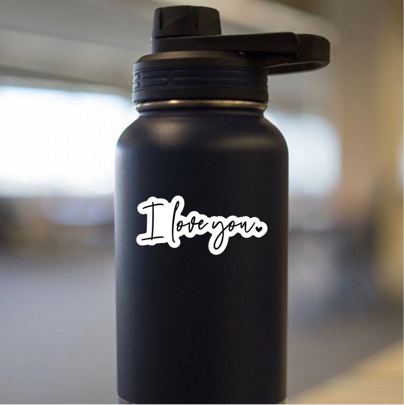 May include: A black stainless steel water bottle with a white sticker that says "I love you" with a small heart.