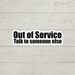 May include: White sticker with black text that reads "Out of Service Talk to someone else".