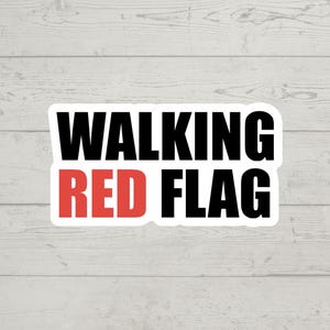 Puede incluir: Una pegatina blanca con texto negro que dice "WALKING RED FLAG" con la palabra "RED" en rojo.