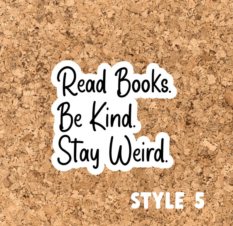 May include: A white sticker with black text on a cork background. The text reads "Read Books. Be Kind. Stay Weird!" and "STYLE 5" in the bottom right corner.