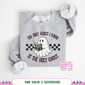 May include: A heather gray crewneck sweatshirt featuring a graphic of a white ghost holding a black Holy Bible. The design includes a black and white checkered stripe and the text, The only ghost I know is the Holy Ghost, in black lettering.