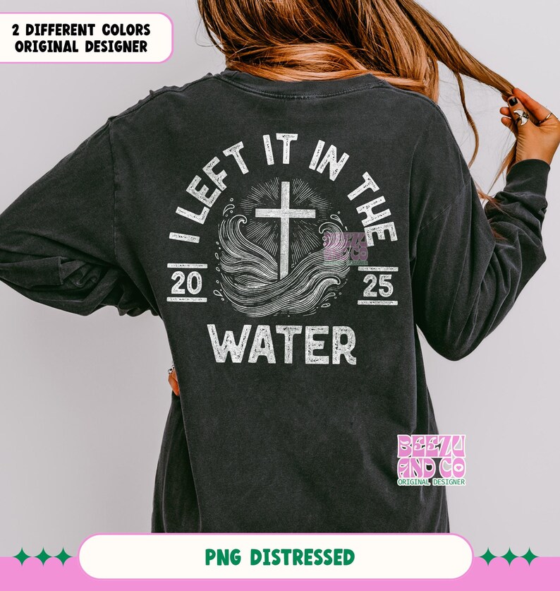 May include: Distressed black long-sleeve shirt with a white graphic of a cross and waves, and the text "I Left It In The Water 20 25".