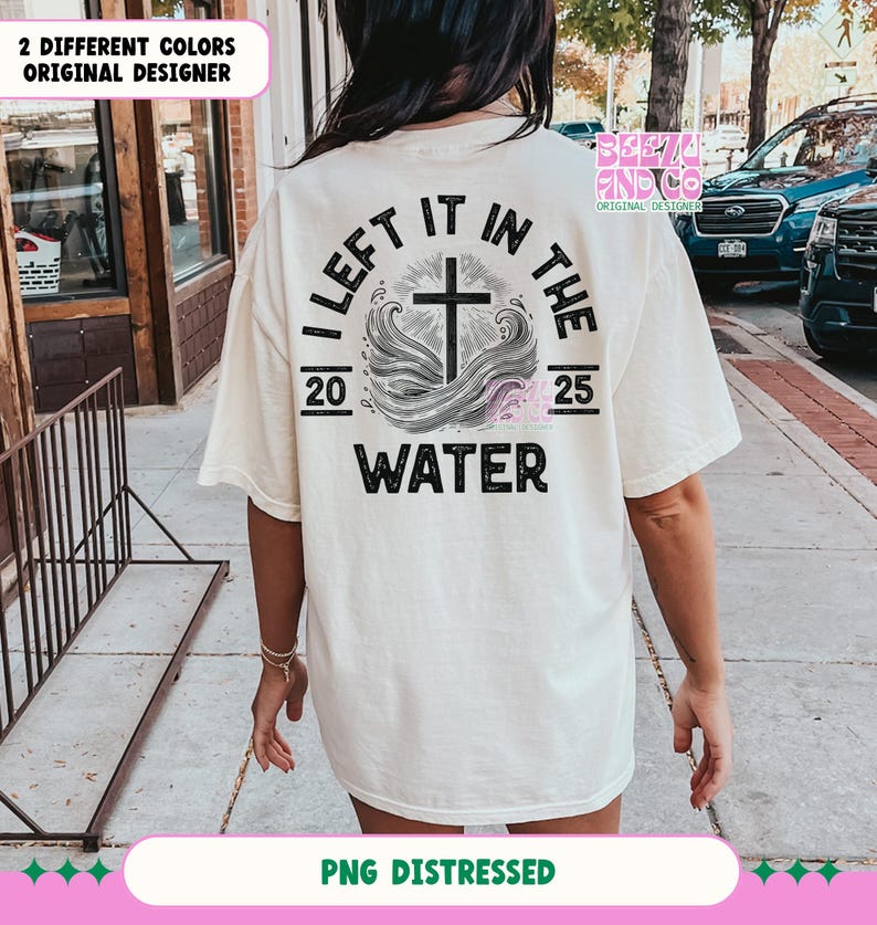 May include: A white t-shirt with a distressed black graphic that says "I left it in the water" with a cross and waves. The numbers 20 and 25 are on either side of the graphic.