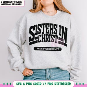 May include: A gray sweatshirt with black text that reads "Sisters in Christ are sisters for life".