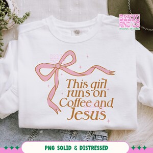 May include: White sweatshirt with a pink bow and the text "This girl runs on Coffee and Jesus" in brown lettering.