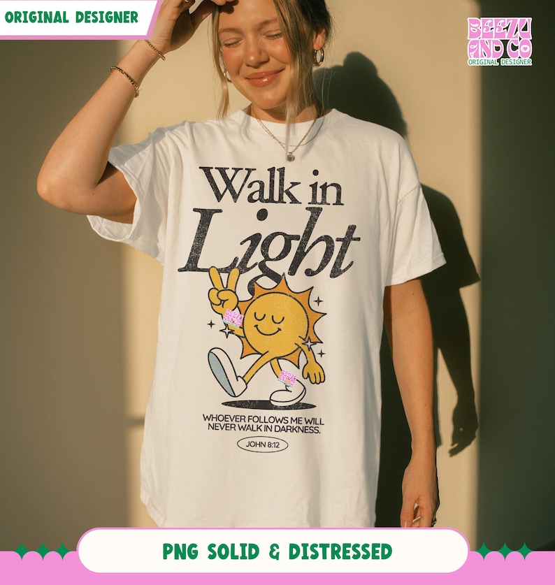 May include: White t-shirt with the words "Walk in Light" in black and a cartoon sun graphic. The sun is yellow with a smiling face and is making a peace sign. The text "WHOEVER FOLLOWS ME WILL NEVER WALK IN DARKNESS. JOHN 8:12" is below the graphic.
