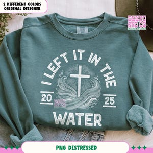 May include: A teal blue sweatshirt with a white distressed graphic that says "I Left It In The Water" with a cross and waves. The graphic also includes the numbers 20 and 25.