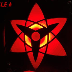 May include: A glowing red star-shaped design with black outlines and a central circular element. The design is labeled "STYLE A" in red text. The background is black with a repeating pattern of red star shapes.
