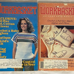 May include: Two vintage issues of The Workbasket magazine, a home arts magazine. The May 1983 issue features a woman wearing a crocheted pullover and the text "Exclusive: Knit Our Cool, Cotton Pullover". The July 1983 issue features a crocheted cat afghan and pillow and the text "Crochet a Purr-fect Match: Afghan and Pillow".