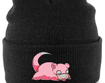 May include: Black knit beanie featuring a pink cartoon character with a white-tipped tail. The beanie is a classic, cuffed style, perfect for cold weather. The embroidered character adds a playful touch to the hat.