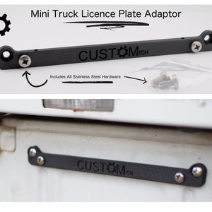 May include: A black metal license plate adapter with the text "CUSTOMISH" engraved on it. The adapter is designed to fit a mini truck and includes stainless steel hardware.