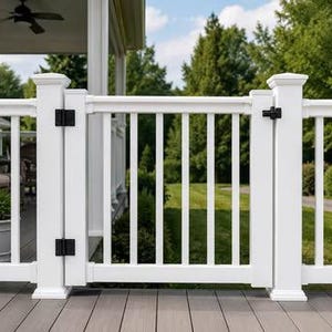 May include: A white vinyl deck gate featuring vertical balusters and two square posts. The gate is equipped with two black metal hinges on the left side and a black metal latch mechanism on the right side, securing the gate to the railing system.