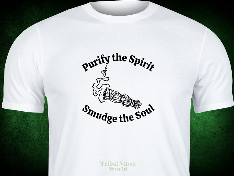 May include: White t-shirt with black text that reads "Purify the Spirit Smudge the Soul" and a black and white illustration of a smudge stick with smoke rising from it. The text "Tribal Vibes World" is printed in the bottom center of the shirt.