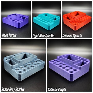 May include: A multi-compartment organizer in various colors: neon purple, light blue sparkle, crimson sparkle, space gray sparkle, and galactic purple. Each organizer has multiple holes and rectangular compartments. The text on the image reads "Neon Purple", "Light Blue Sparkle", "Crimson Sparkle", "Space Gray Sparkle", and "Galactic Purple".