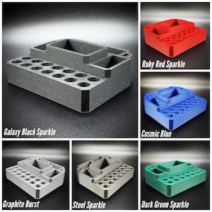 May include: A multi-compartment organizer in various colors, including Galaxy Black Sparkle, Ruby Red Sparkle, Cosmic Blue, Graphite Burst, Steel Sparkle, and Dark Green Sparkle. Features multiple holes and compartments for storage.