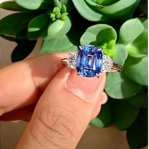 The Royal Horizon Ring, &quot;Elegant Cushion Cut Blue Sapphire Ring with Diamond Accents – Classic Three Stone Engagement Ring&quot;