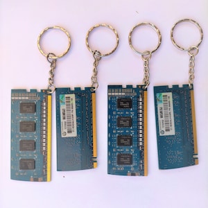 May include: Four blue and gold RAM memory chips attached to silver keychains. The chips have labels with the text "2GB 2Rx8 PC3-10600S-9-10-F3 81-99999-001 HP", "2GB 2Rx8 PC3-10600S-9-10-F3 81-99999-001 HP", and "2GB 2Rx8 PC3-10600S-9-10-F3 81-99999-001 HP".