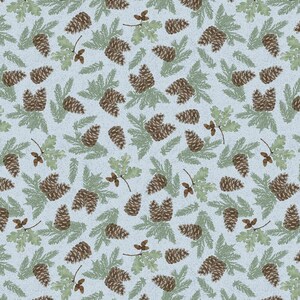 May include: A light blue fabric featuring a repeating pattern of brown pinecones, green pine needles, and small green oak leaves with tiny brown acorns. The design is evenly spaced across the surface, creating a nature-inspired botanical print.