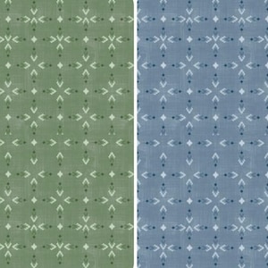May include: Two rectangular fabric swatches featuring a repeating geometric pattern. One swatch is sage green and the other is slate blue. Both display a white, symmetrical, star-like motif arranged in a grid, set against a subtle, textured background.
