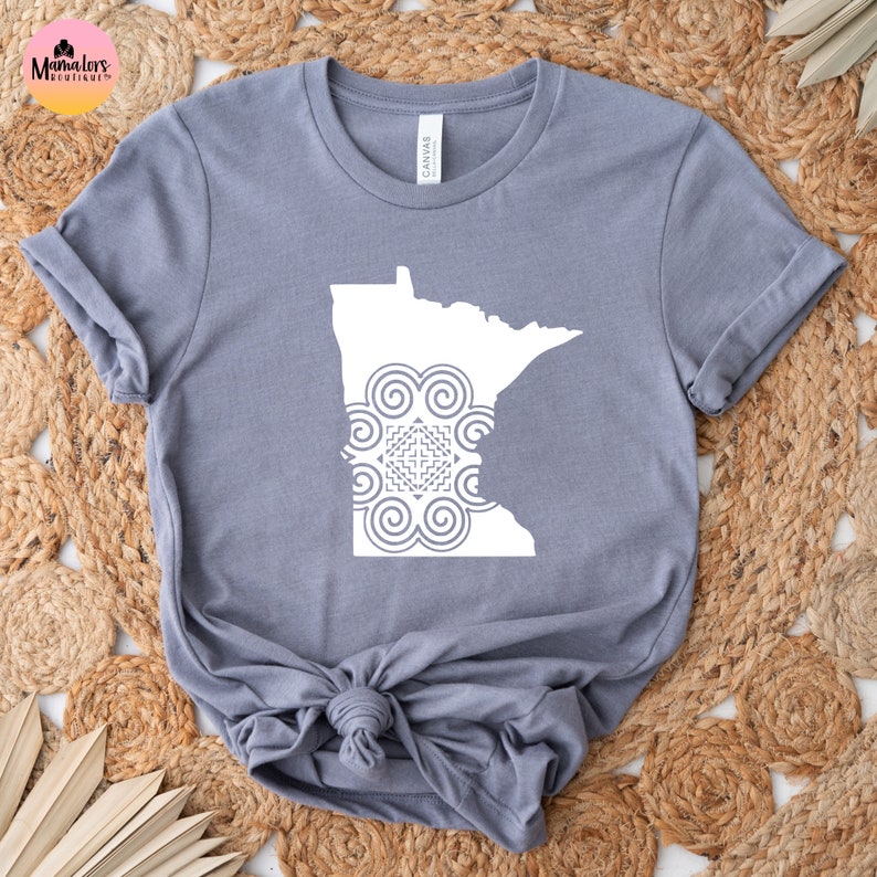 May include: A gray t-shirt with a white outline of the state of Minnesota with a stylized geometric design inside.